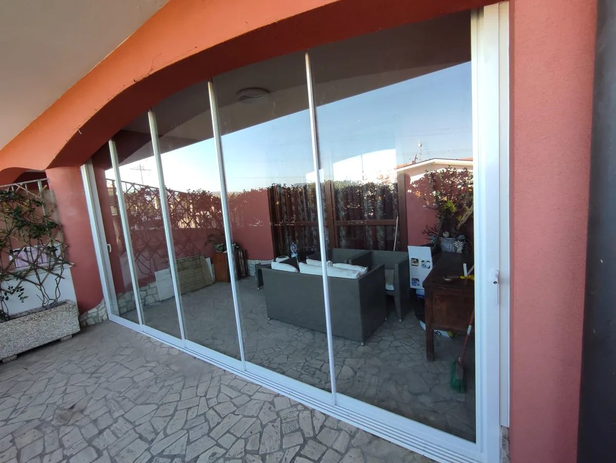 Vetrata scorrevole VePA in alluminio bianco su terrazzo — chiusura balcone senza permessi IS Metal srl